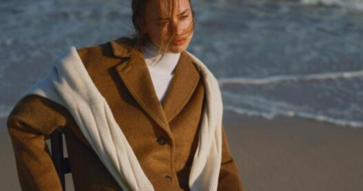 a woman sitting on a beach