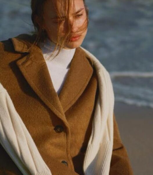 a woman sitting on a beach